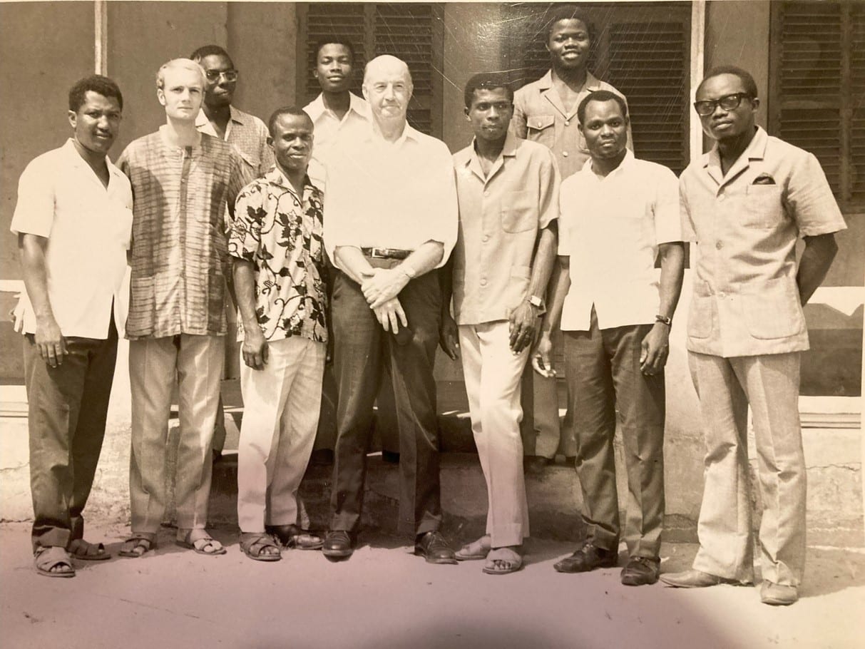 Russell Love's father (center) with Russell (second from left) during a visit two years after service. Etienne stands in between the two.